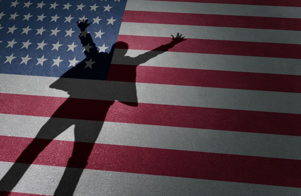 Man's shadow over American flag