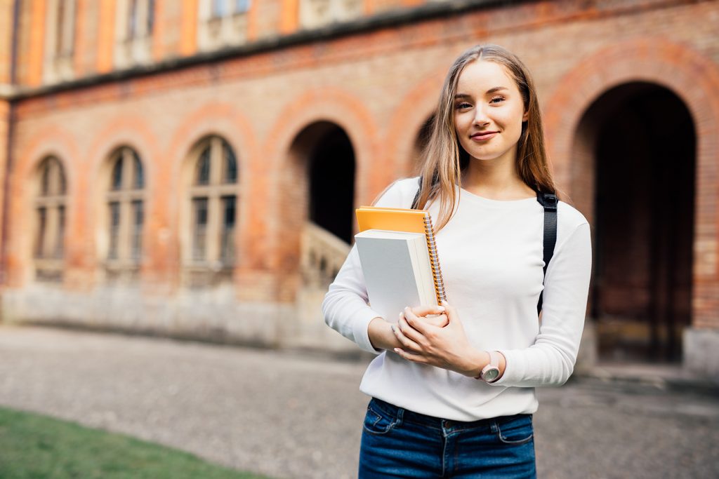 Photo of a Student holding a notebook